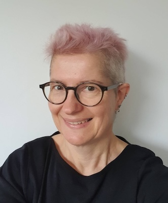 profile picture where I'm smiling. I'm a middle age white woman with short pink hair and round glasses